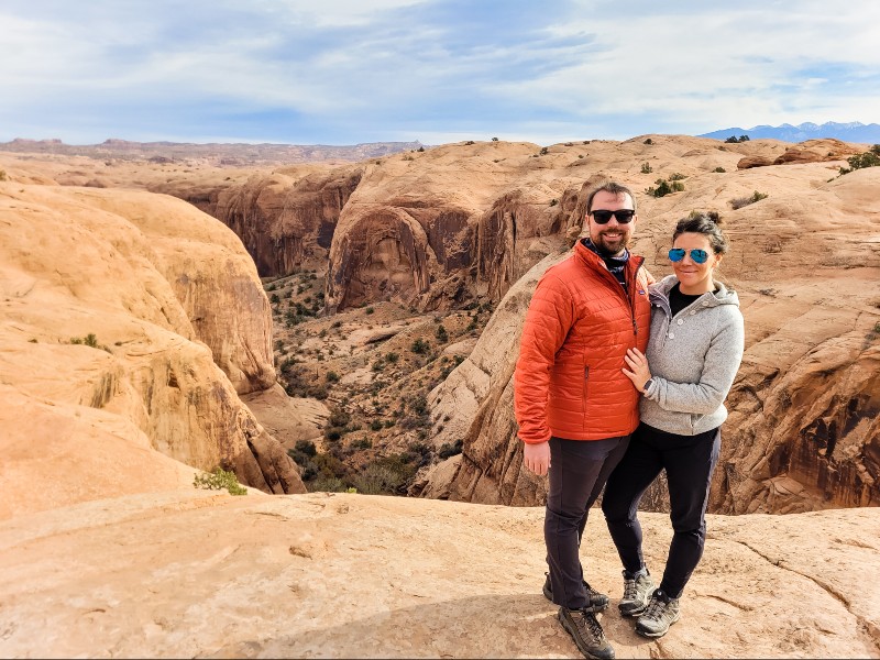 Two people posing near a canyon along one of the off road trails in Moab
