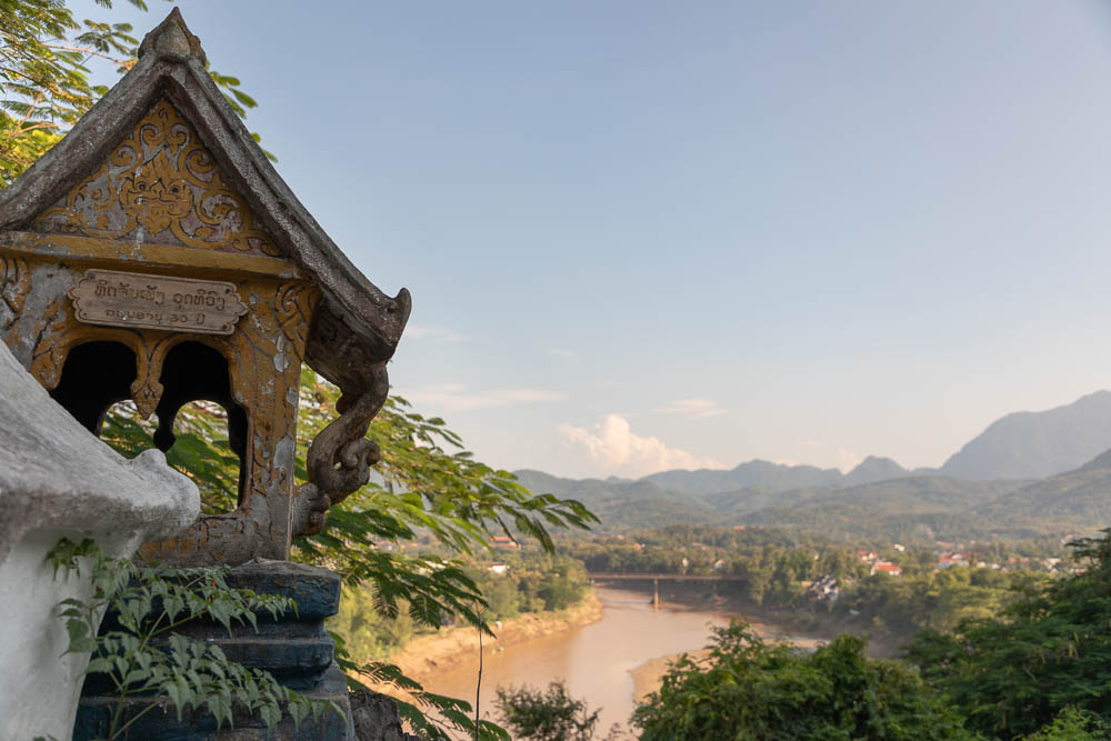 Mountains, lush rainforest, and a building in Luang Prabang, Laos, one of the world's most underrated countries