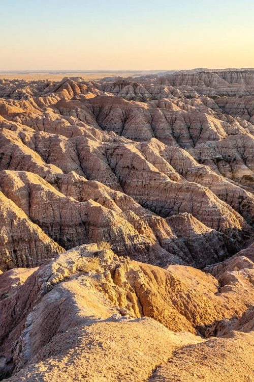 Pictures of the Badlands in South Dakota with the golden hour glow of sunset
