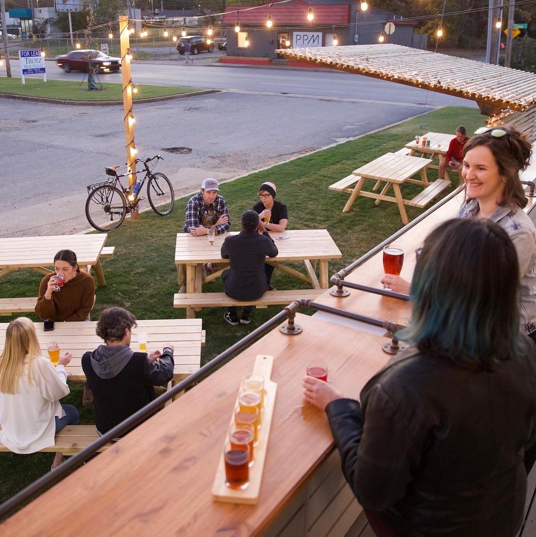 Several people enjoying beers outside at Hampline Brewing, one of the newer Memphis breweries