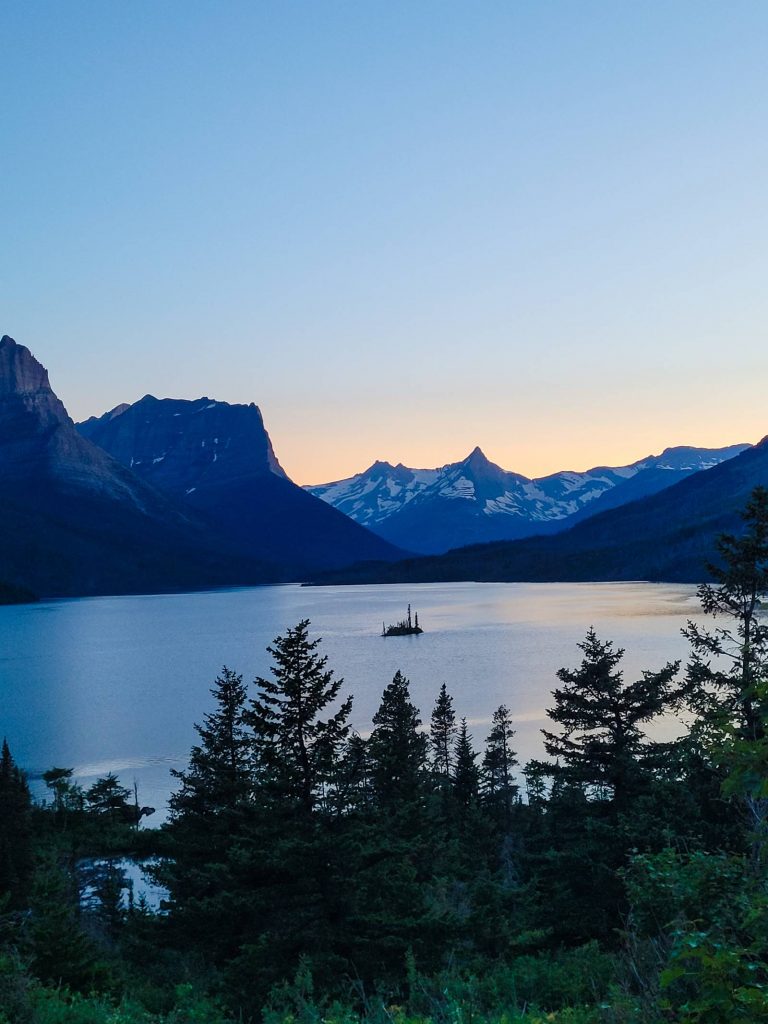 A glacial lake at sunset in Glacier National Park, one of the units the national park annual pass gets you into