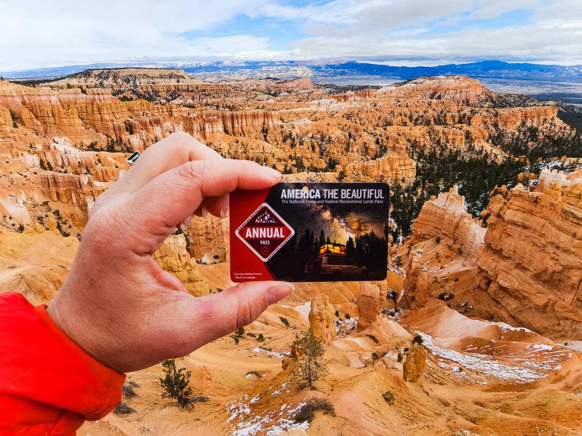 A hand holding the 2023 National Parks Annual Pass at Bryce Canyon