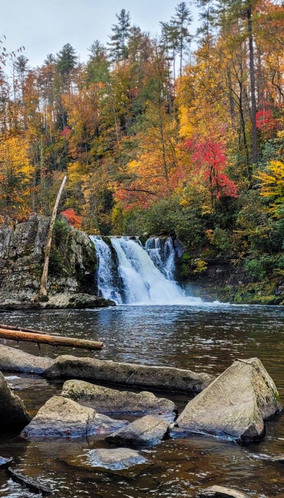 Abrams Falls surrounded by colorful fall foliage, one of the best Smoky Mountain waterfalls