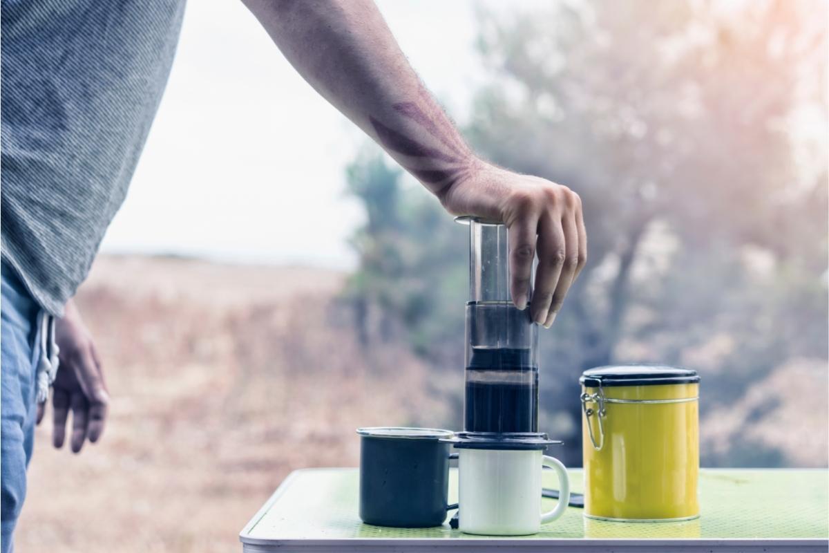 A man pressing coffee in an Aeropress, one of the best camp French press models available