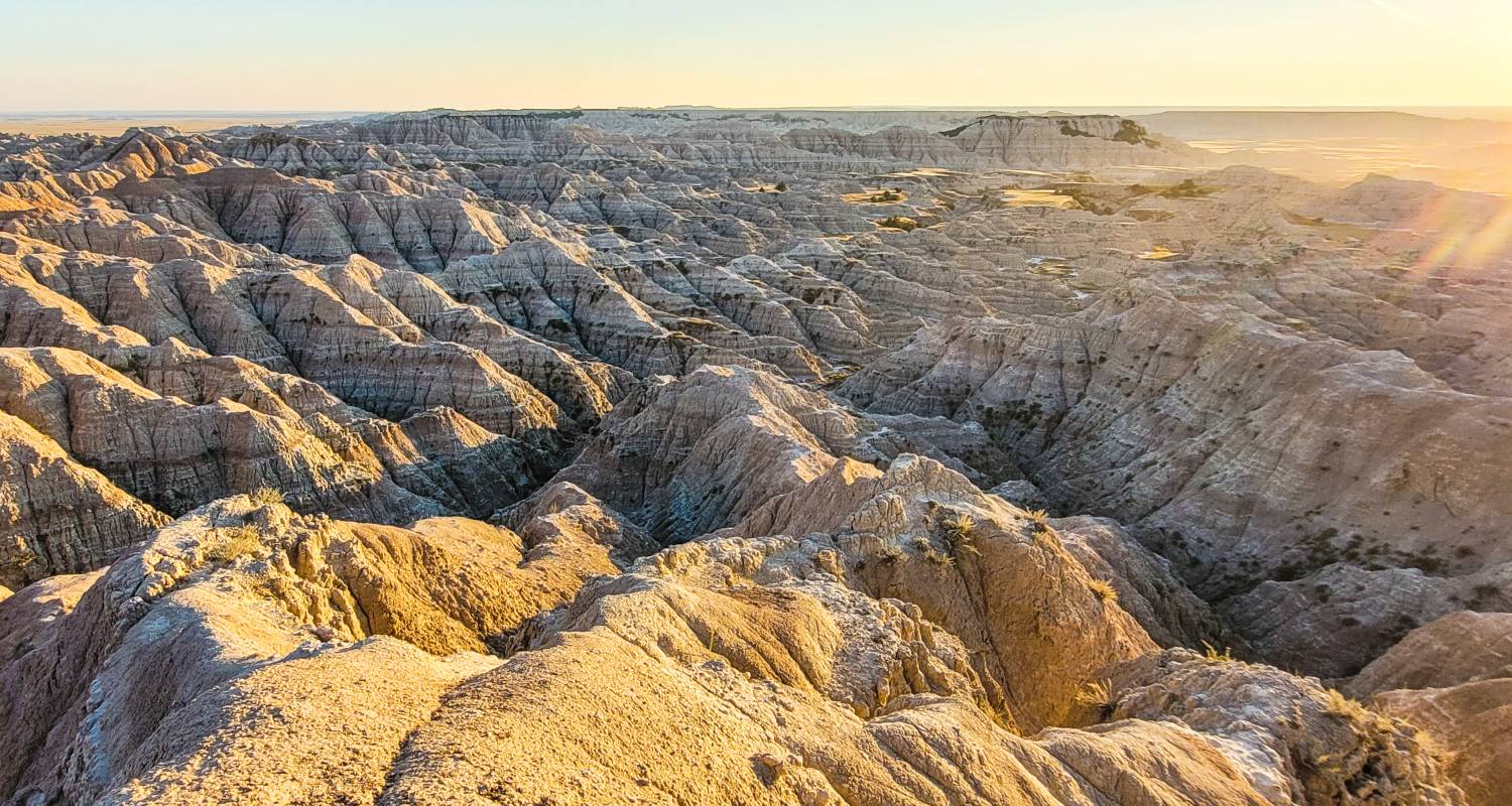 Sunset over badlands formations in the Sage Creek Wilderness section of the park, one of the best Badlands hikes