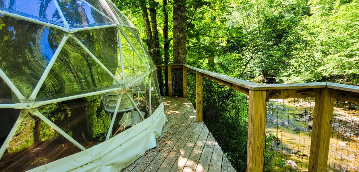 The edge of a geodesic dome tent and its deck at Glamping Unplugged North Carolina