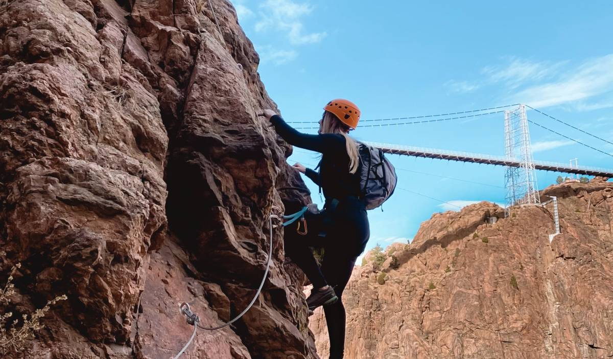 A woman climbing the via ferrata at the Royal Gorge Colorado