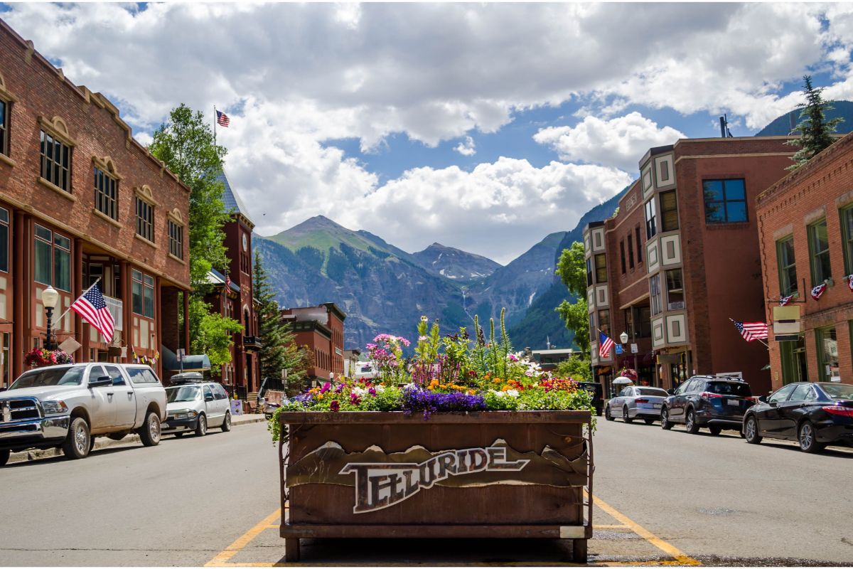 The main street in downtown Telluride, one of the best mountain towns in Colorado, with the huge mountains in the background
