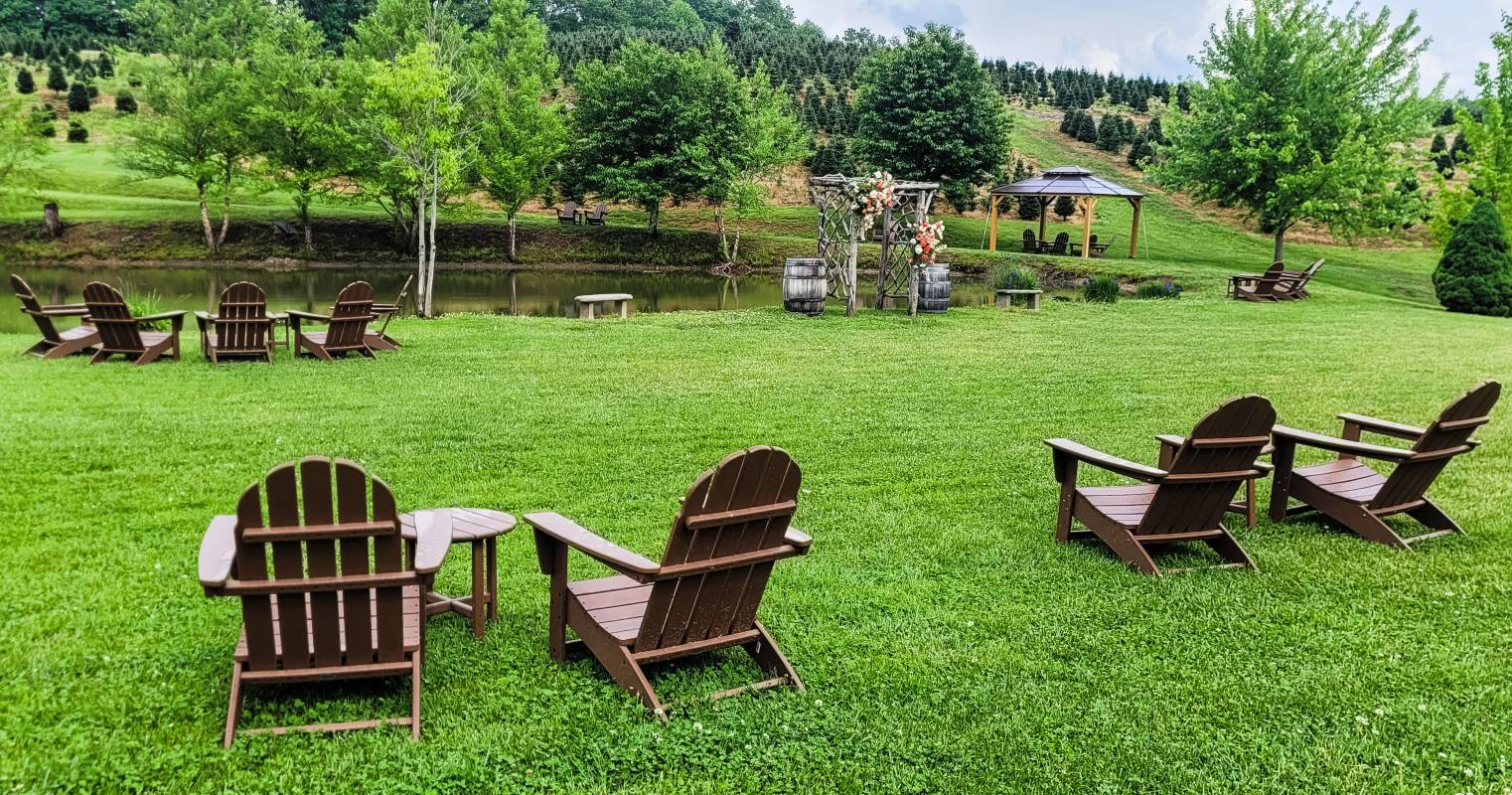 Adirondack chairs on a lawn near a pond at Linville Farms Winery, one of three Boone wineries