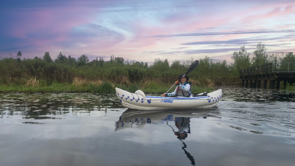 A woman paddling solo in a Sea Eagle 330 inflatable kayak