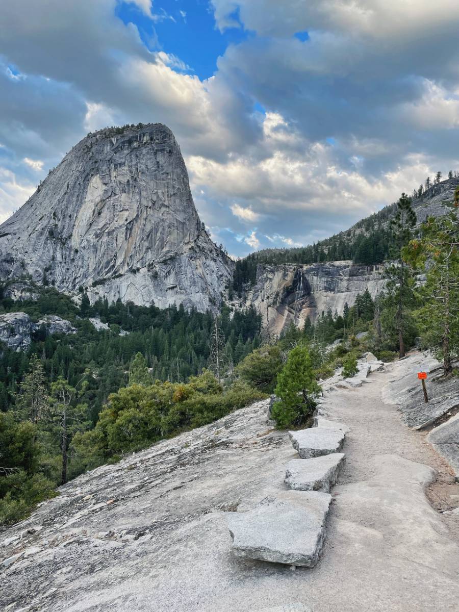 point of view looking back at the liberty cap and Nevada fall at half dome
