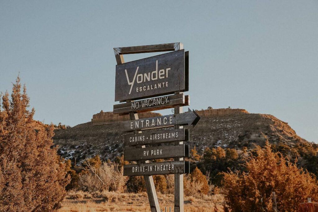 The Yonder Escalante sign, in front of red cliffs