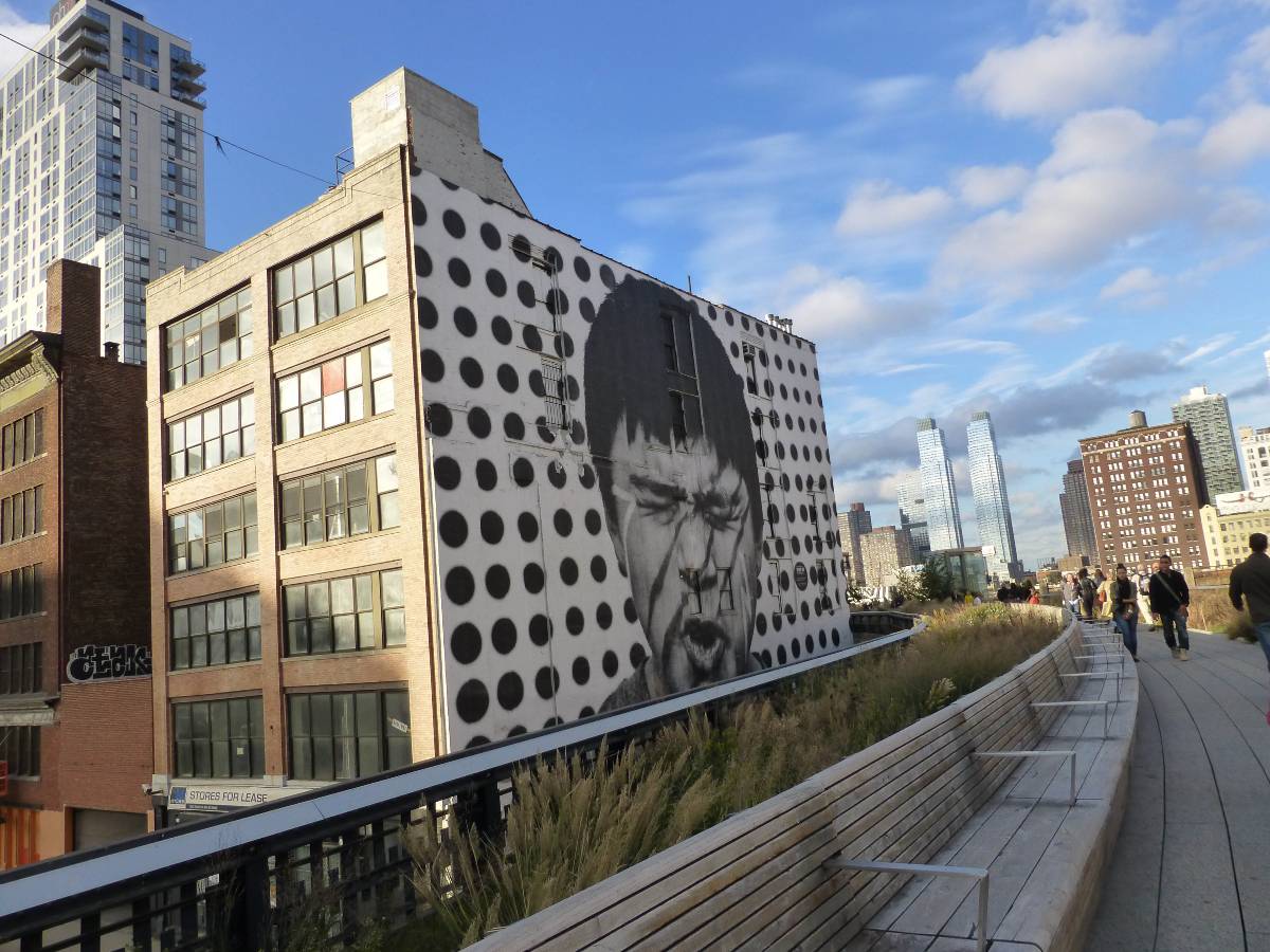 A black and white mural alongside the High Line in NYC