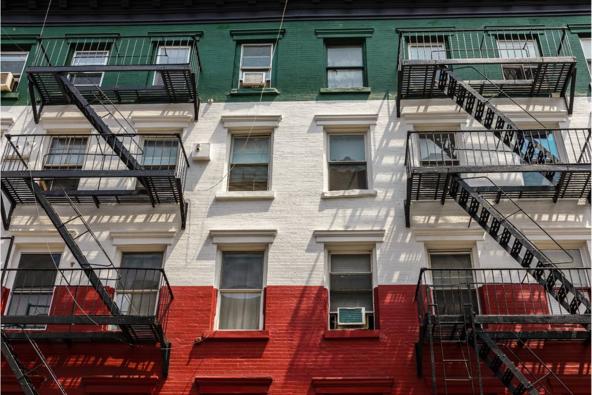 Red, white, and green building facades in Little Italy, NYC